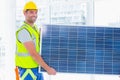 Manual worker carrying solar panel at office Royalty Free Stock Photo