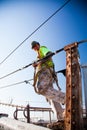 Manual worker climbing the Brooklyn Bridge