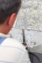 Manual worker disassembling old floor tiles Royalty Free Stock Photo