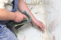 Manual worker disassembling old floor tiles Royalty Free Stock Photo