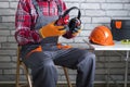 . Manual worker putting protective headphones.