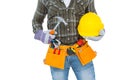 Manual worker wearing tool belt while holding hammer and helmet Royalty Free Stock Photo