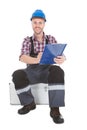 Manual worker writing on clipboard over white background Royalty Free Stock Photo