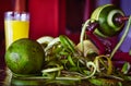 Manually peeling fresh ripe green oranges for orange juice with a manual vintage orange and apple peeler