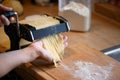 Manually selfmade noodles pasta with machine on wood Royalty Free Stock Photo