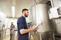 Men with clipboard at craft brewery or beer plant Royalty Free Stock Photo