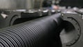 Manufacture of plastic water pipes. Manufacturing of tubes to the factory. The process of making plastic pipes on the
