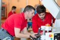 Manufacture workers working on electronic machine Royalty Free Stock Photo