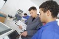 Manufacture workers working on electronic machine Royalty Free Stock Photo