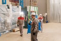 Manufacture workshop. move the crane with beam. Workers adjusts the machine in the warehouse. the production of Royalty Free Stock Photo