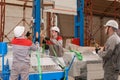 Manufacture workshop. move the crane with beam. Workers adjusts the machine in the warehouse. the production of Royalty Free Stock Photo