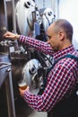 Manufacturer filling beer from storage tank at distillery Royalty Free Stock Photo