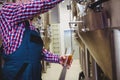 Manufacturer filling beer from storage tank Royalty Free Stock Photo