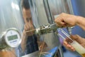 Manufacturer pouring beer in glass from machine at brewery Royalty Free Stock Photo