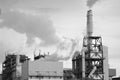 Industrial plant spews clouds into gray sky