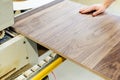 Manufacturing of high quality veneer furniture. The process of gluing an edge onto a manufactured part using a specialized machine Royalty Free Stock Photo