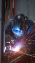 Manufacturing precision Close up of a welder starting work in an industrial setting Royalty Free Stock Photo