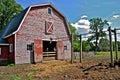 Manure carrier on an old red barn Royalty Free Stock Photo