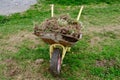 Manure in a cart in the garden in the spring. The land is in a cart. The cart is old and rusty. A vegetable garden and a Royalty Free Stock Photo