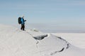 Manwith a backpack is skiing on theice of the frozen river