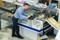 manworking on printing machine in print factory Royalty Free Stock Photo