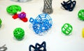 Many abstract models printed by 3d printer close-up.