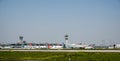 Many airplanes at the terminals of the Istanbul airport with control towers and hangars