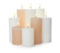 Many alight wax candles on white