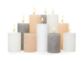 Many alight wax candles on white