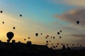 Many amazing hot air balloons flying over Cappadocia rocks in Turkey.
