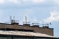 Many antennas on the roof of the building