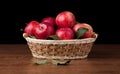 Many apples in the basket on the wood desk Royalty Free Stock Photo