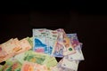 Many Argentine bills scattered on a table