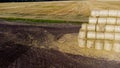 Many bales rolls straw after harvest collected together field autumn summer day. Royalty Free Stock Photo