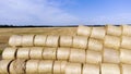 Many bales rolls straw harvest collected together field sunny autumn summer day. Royalty Free Stock Photo