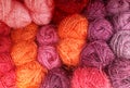 Many balls of wool yarn in natural shades of rose  orange  pink and purple for knitting  crocheting Royalty Free Stock Photo