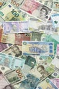 Many banknotes of different currency. Background of big amount of random money bills Royalty Free Stock Photo