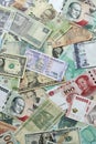 Many banknotes of different currency. Background of big amount of random money bills Royalty Free Stock Photo