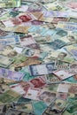 Many banknotes of different currency. Background of big amount of random money bills Royalty Free Stock Photo