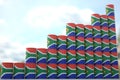 Steel oil drums with flag of South Africa form increasing chart or upwards trend. Petrochemical industry growth concept