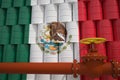 Many barrels with flag of Mexico and oil pipe. 3d rendering