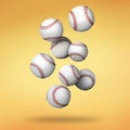 Many baseball balls falling on golden gradient background Royalty Free Stock Photo