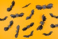 Many bats made of paper on an orange background. Flat lay. The concept of Halloween, and holiday decorations Royalty Free Stock Photo