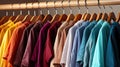 Many beautiful fashionable bright multi-colored shirts on hangers