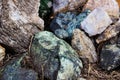 Many beautiful large colored stones are collected in a heap in nature, in the country. Stones close-up, background. Large stones