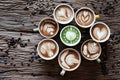 Beautiful lattes, many multi-colored glasses placed on the old wooden floor. Coffee beans are placed around. Royalty Free Stock Photo