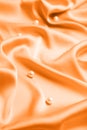 Many beautiful pearls on delicate orange silk