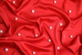 Many beautiful pearls on delicate red silk, top view Royalty Free Stock Photo