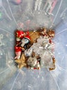 Many beautiful shiny colorful different Christmas Tree toys in transparent plastic box. Christmas decorations. Top view. Royalty Free Stock Photo