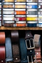 Many Belts Rolled Up And Lots Of Jars Of Shoe Polish Royalty Free Stock Photo